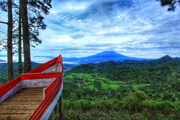 ảnh nền đẹp núi lửa xanh mát seen from red-roofed hillside viewpoint with dramatic cloudy sky